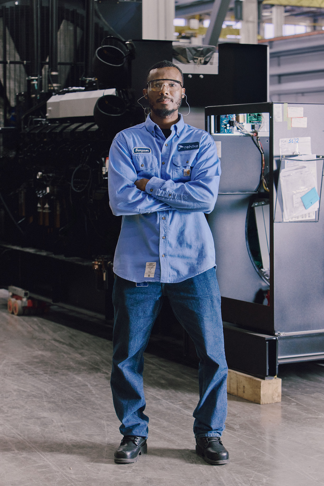 Man standing in front of computer in Rehlko factory